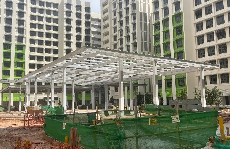 Steel-framed pavilion structure on the Tengah PA C1 & CG site, with residential blocks behind.